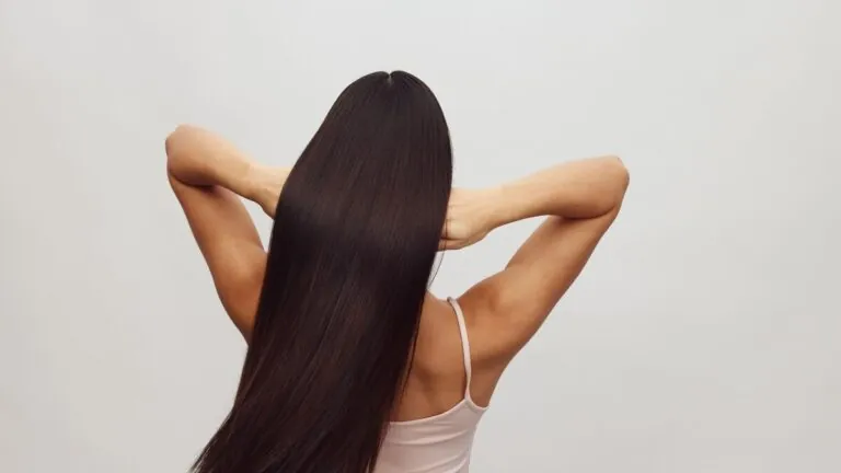Woman with long straight dark hair seen from behind
