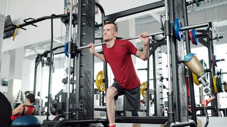 Man training legs with a barbell in a gym