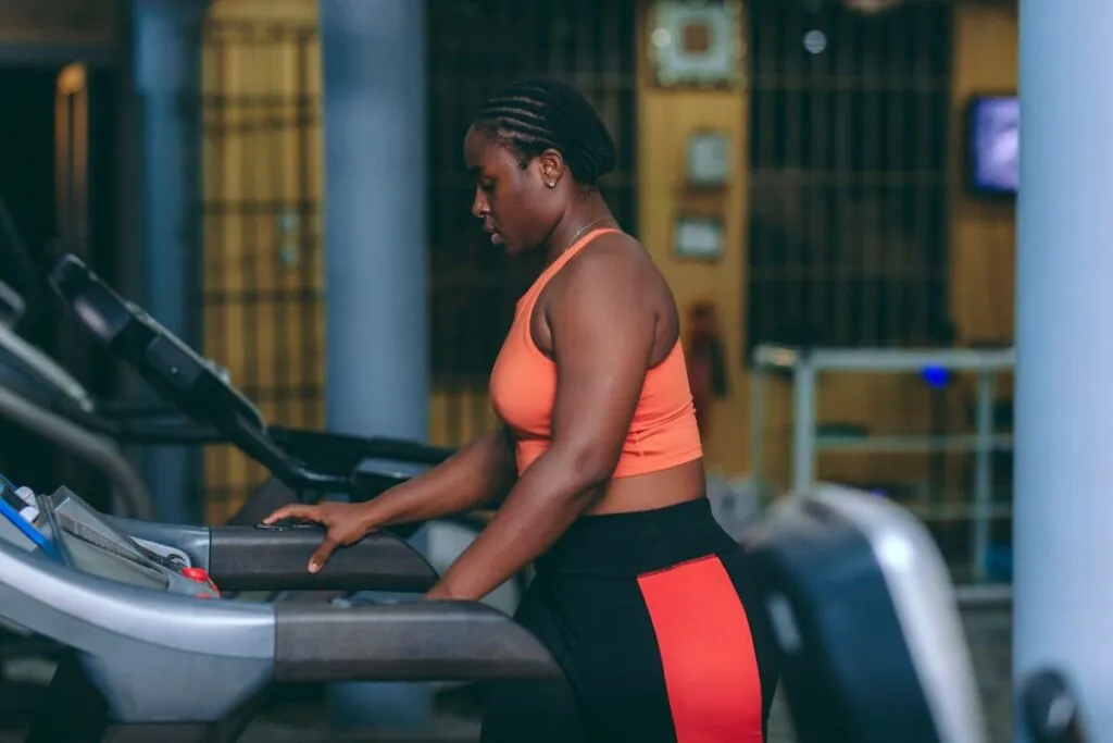 Woman walking briskly on a treadmill in a gym