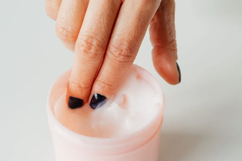 Finger scooping cream from a jar