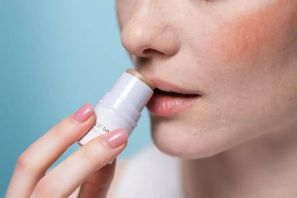 Woman applying lip balm