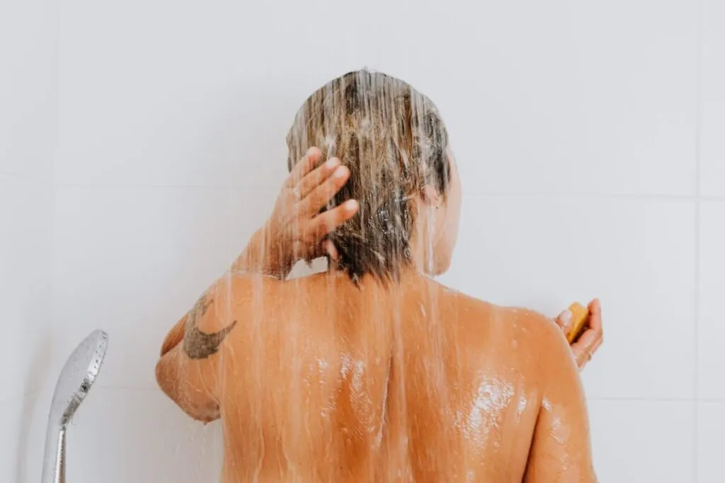 Woman rinsing her hair in the shower on wash day