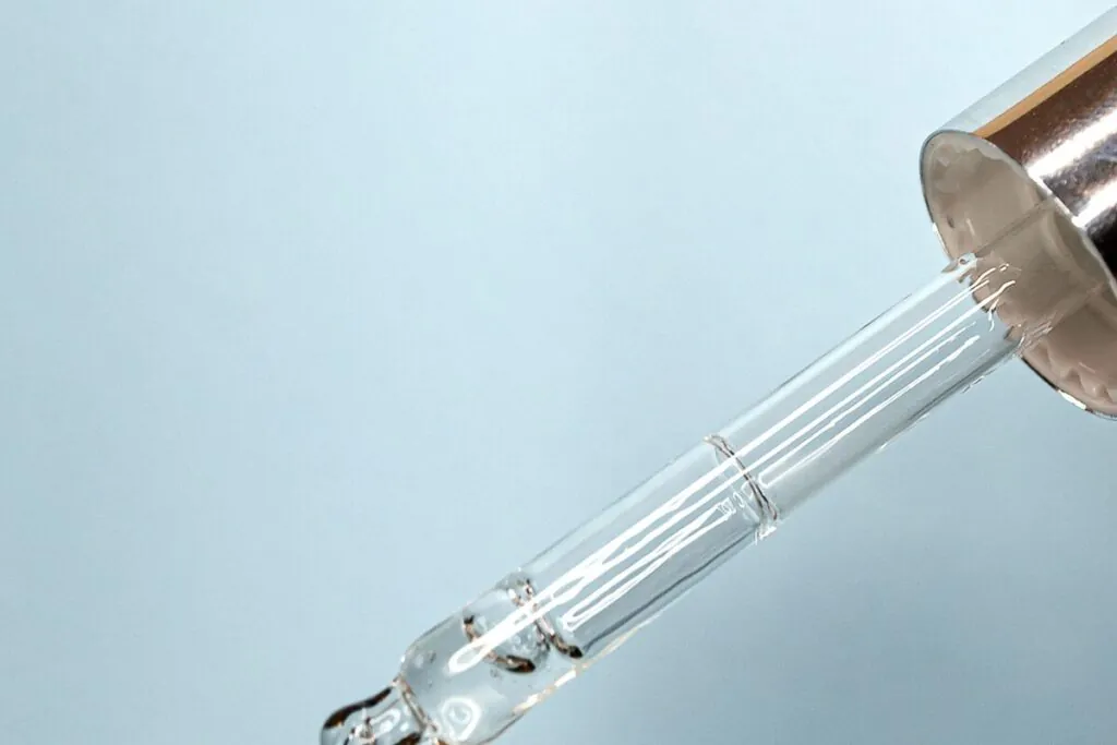Dropper releasing a drop of serum
