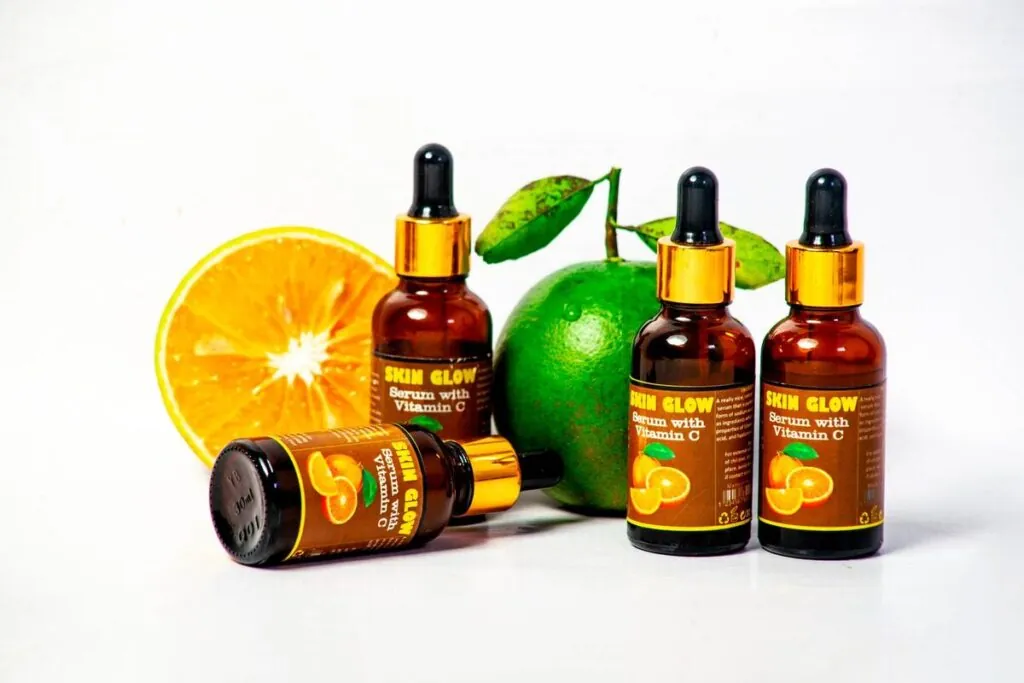Vitamin C serum bottles with fresh citrus fruit