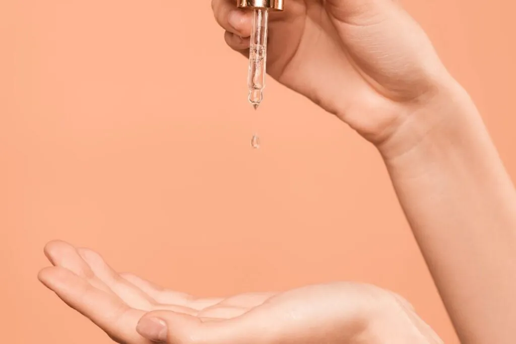 Serum dropping from a pipette into an open palm